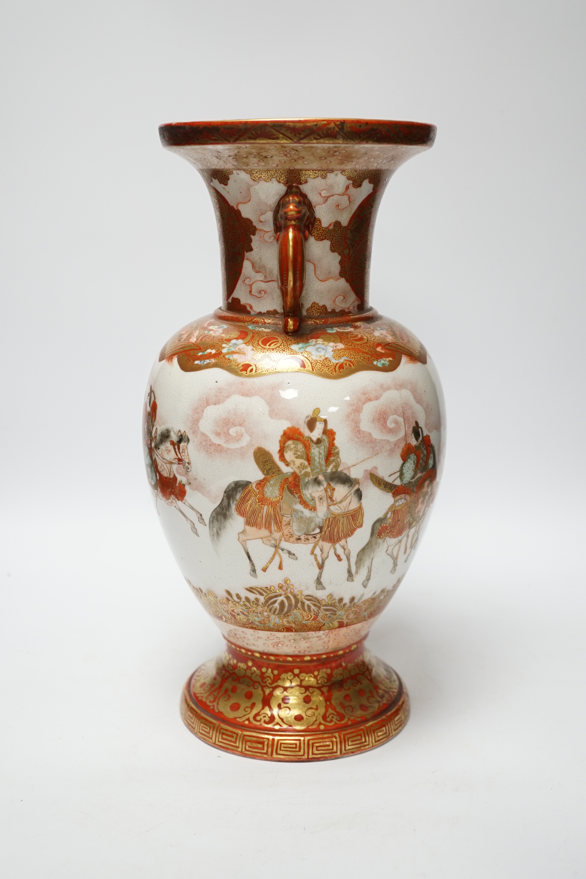 A Japanese Kutani porcelain twin handled vase, Meiji period, decorated with warriors on horseback, 34.5cm high